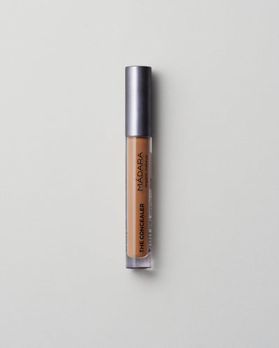 MÁDARA Organic Skincare amber concealer madara cosmetics A6115 concealer product photo on plain background.