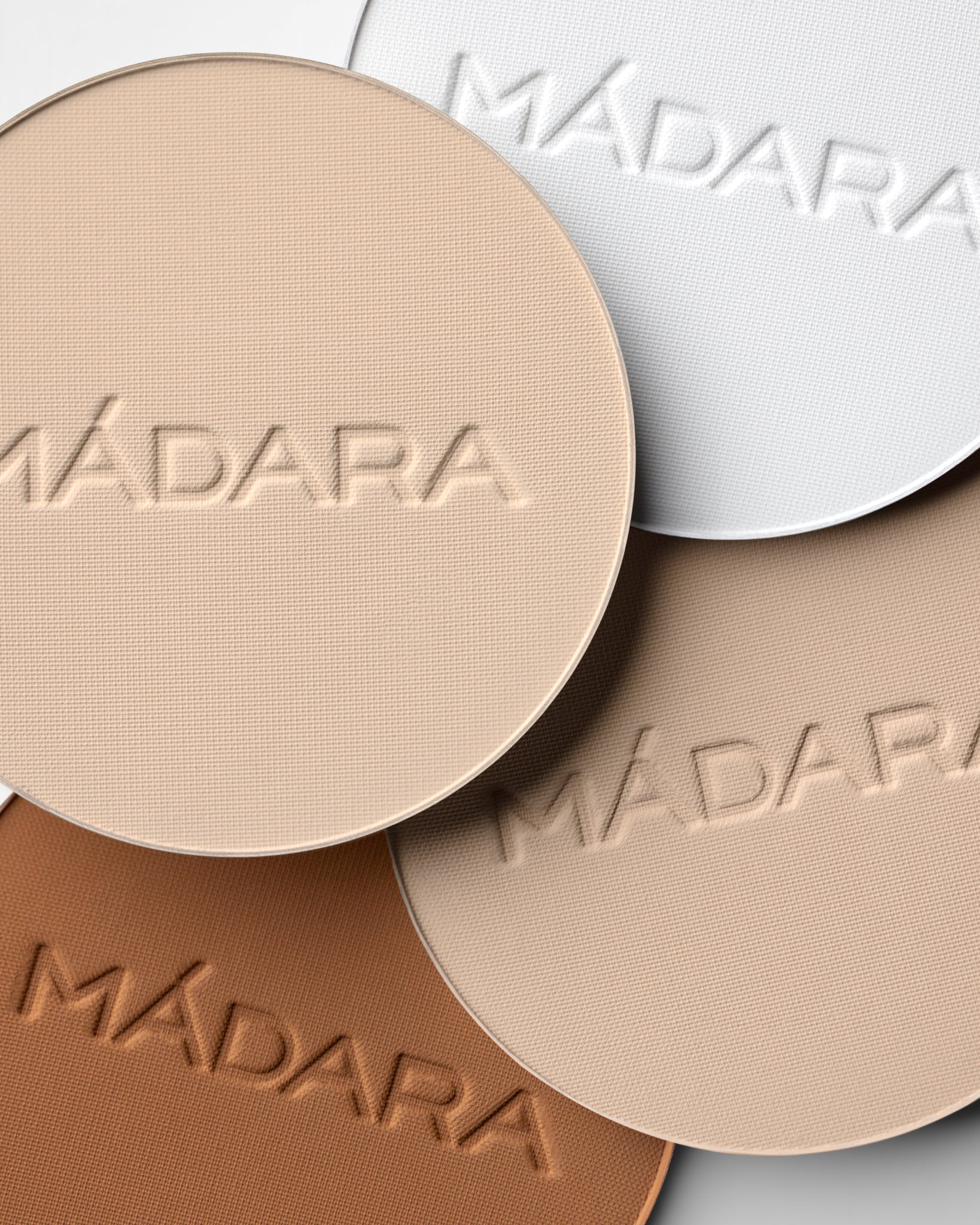 Texture close-up of MÁDARA Organic Skincare soft silk mineral powder textures A6803 �swatch demonstrates consistency and finish.